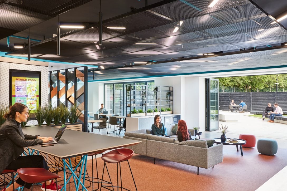 People are shown working within an open collaborative space, an office design trend on the rise. 