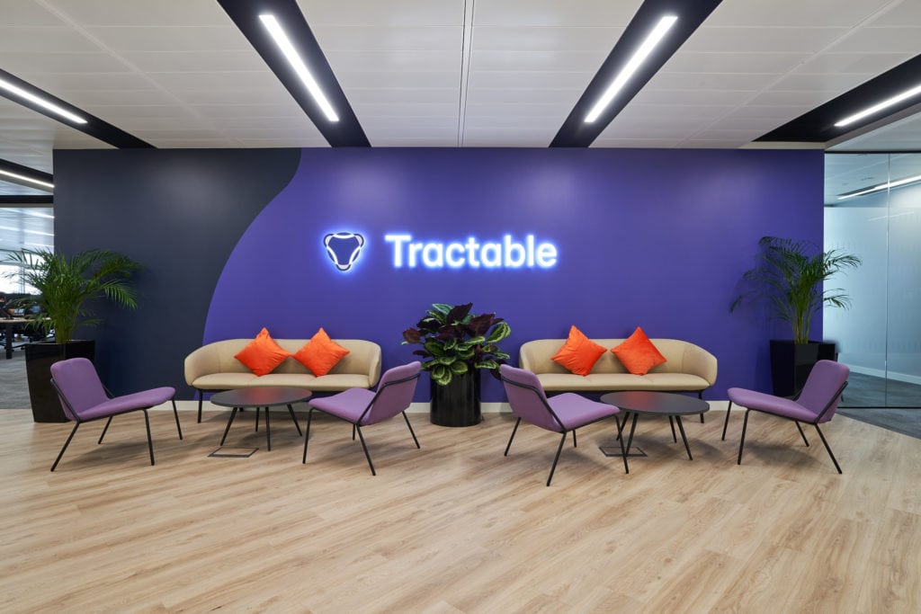 Tractable staff lounge with purple feature wall in the company's brand colours.
