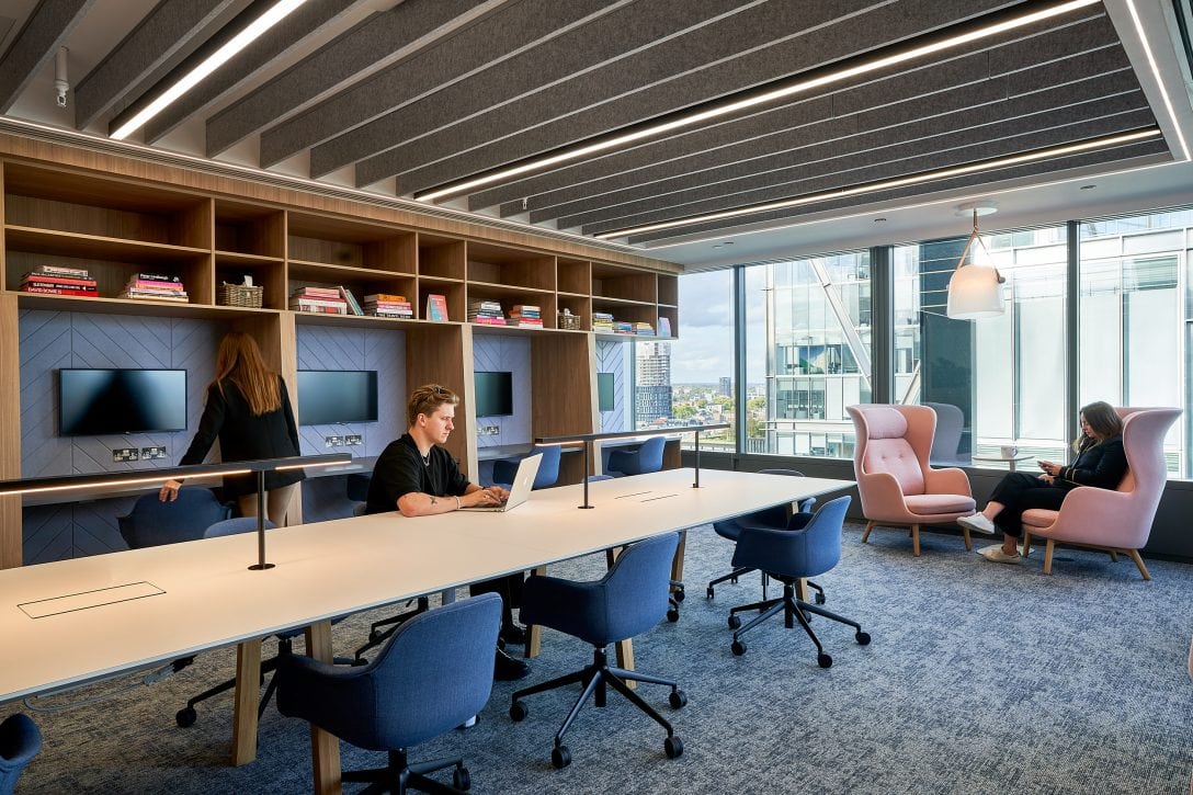 Employees are shown inside an office library space that was designed for focussed productivity. 