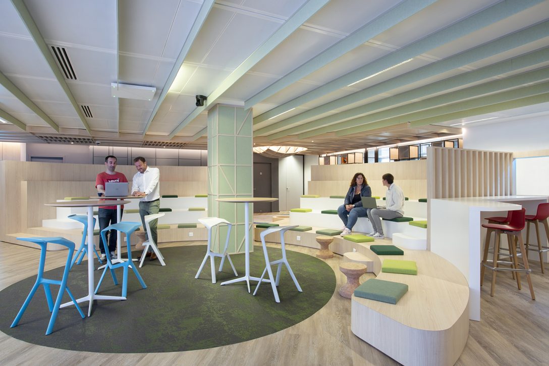 Workers collaborate within a breakout area in AIS' most recent Paris project. 