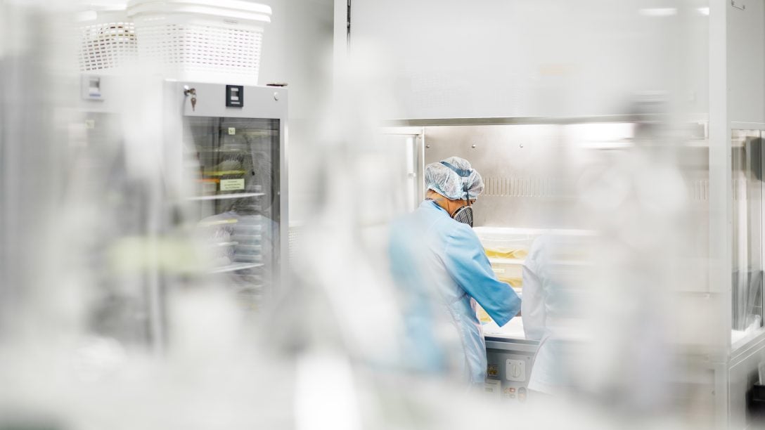 Man shown with protective gear on working in a laboratory for the production of biomaterials. 